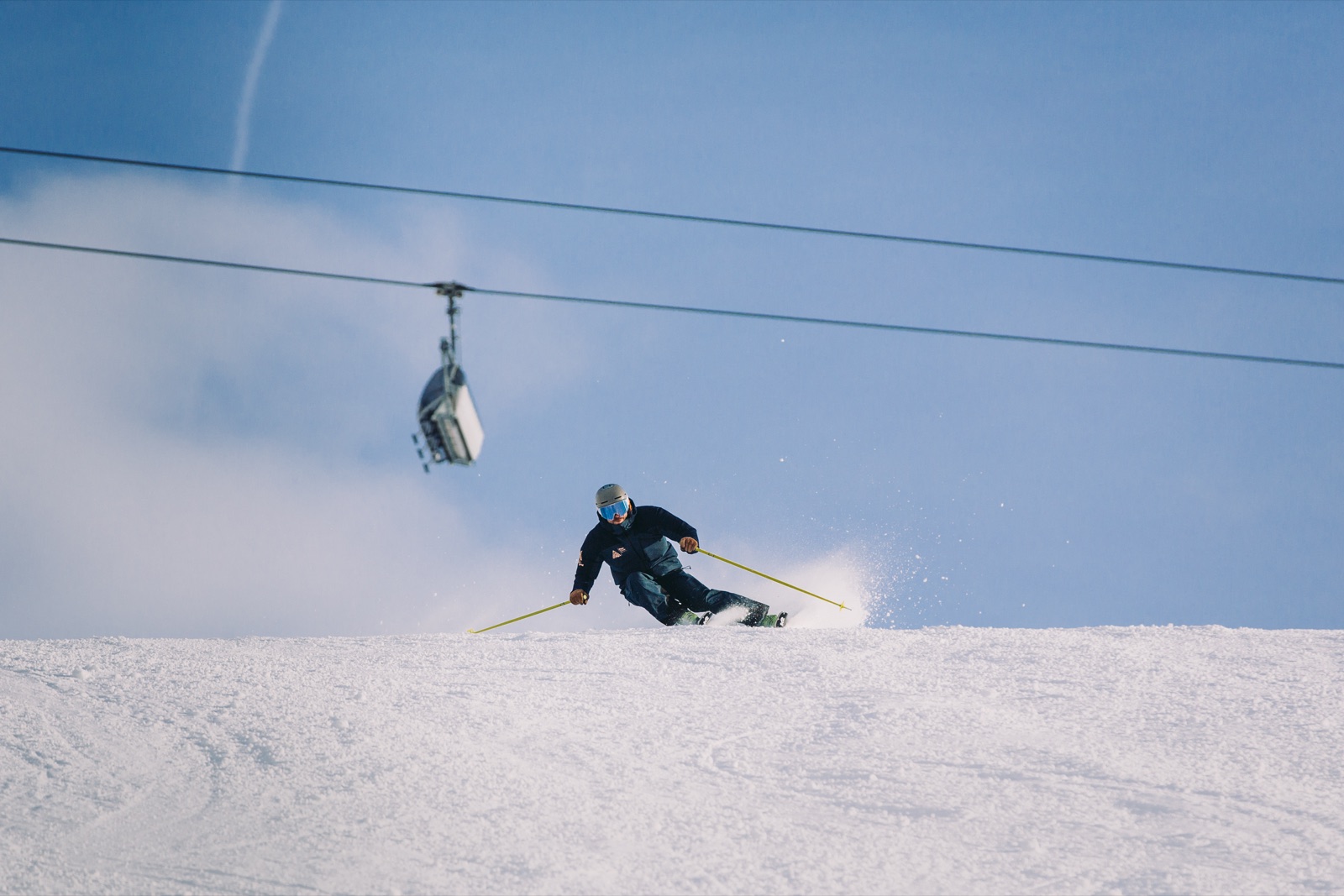 Marc on piste with a chairlift overhead