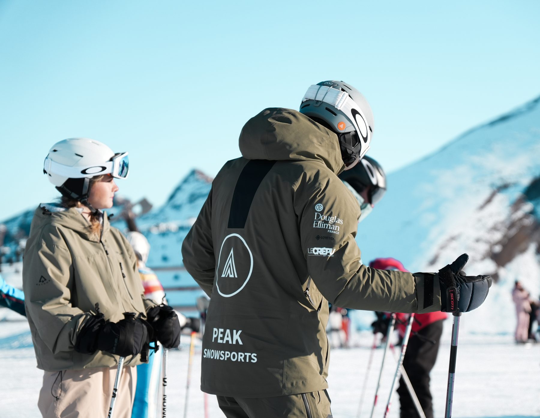 A Peak instructor with students on the piste